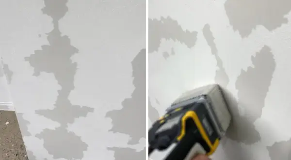 Le mur en toile de verre présente des zones abîmées, comme des taches d'humidité. Un outil est utilisé pour évaluer les dégâts.