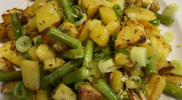 Herzhafte Kartoffel-Bohnen-Pfanne mit Frühlingszwiebeln, goldbraun gebraten und mit Kräutern verfeinert. Ein Genuss!