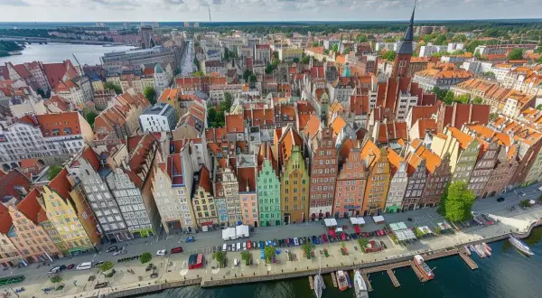 Gdańsk podział na dzielnice: widok z lotu ptaka na kolorowe kamienice przy Motławie, z łodziami i statkami.