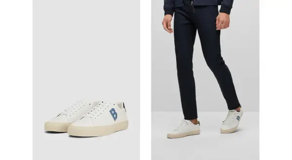 Outfit elegante con sneakers uomo: pantaloni blu scuro e scarpe bianche con logo blu.