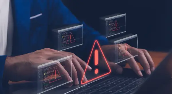 Osoba pisze na klawiaturze, a na ekranie pojawiają się ostrzeżenia. Czy to znak, że mamy do czynienia ze spyware?
