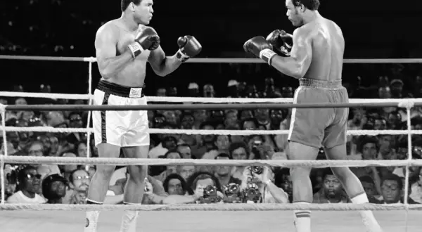 Muhammad Ali faces his opponent in the ring, a moment captured from one of his greatest fights.