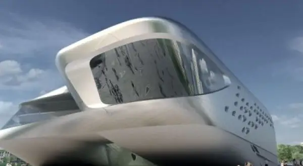 Futurystyczny budynek w kształcie łodzi, dzieło Zaha Hadid, lśni w słońcu. Ludzie spacerują przed jego niezwykłą fasadą.