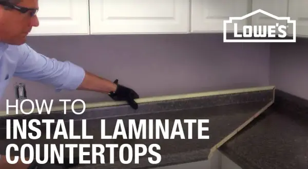 Learn how to install laminate countertops with this helpful guide. A person in gloves is shown working on a countertop.