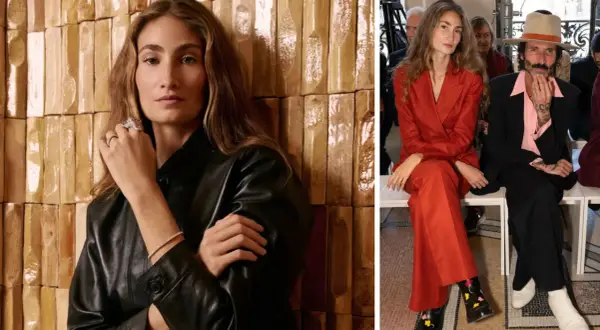 Almudena Cañedo, elegante en traje rojo, y un hombre con sombrero y traje negro, sentados en un evento.