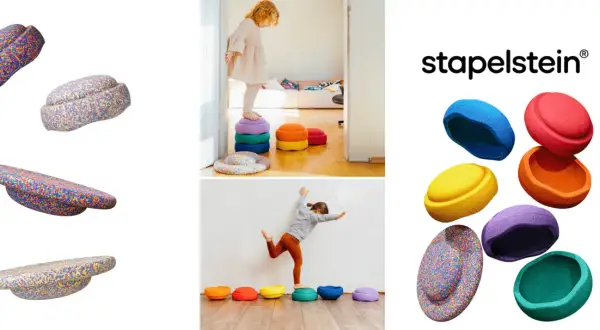 Bunte Stapelsteine regen Kinder zu kreativen Spielideen an. Kinder balancieren und stapeln die bunten Steine.