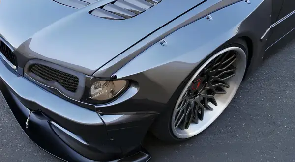 Agresywny tuning BMW E46 z poszerzeniami błotników i sportowym zderzakiem.