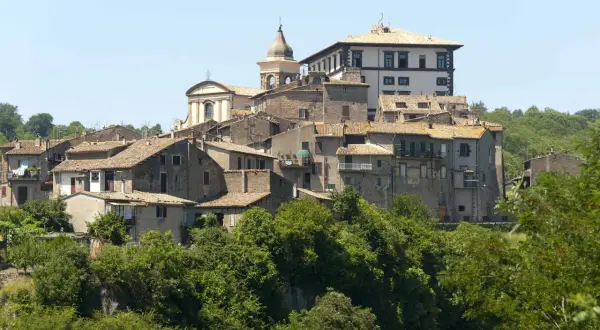 Borgo medievale di Gradoli, affacciato sul lago di Bolsena, con case in pietra e una chiesa con campanile.