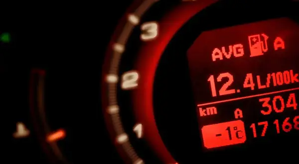 Wyświetlacz pokazuje, jak obliczyć ile auto pali: średnie spalanie 12.4L/100km. Widoczny też dystans i temperatura.