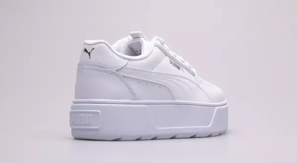 Białe buty na platformie Puma Karmen Rebelle Jr. z czarnym logo.