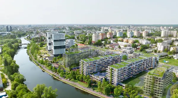 Nowoczesne osiedle apartamentowe z zielonymi dachami nad rzeką w Bydgoszczy.