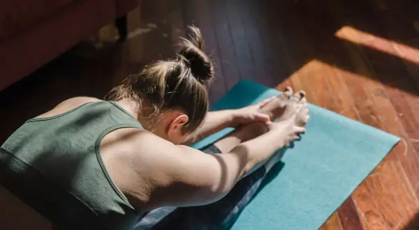 Mujer en postura de yoga, buscando el samadhi significado en la quietud.