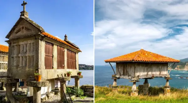 Dos hórreos, uno de piedra con cruz y otro de madera, se alzan sobre pilares en la costa de Asturias.