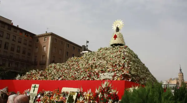 Ofrenda de flores gigante para el programa de fiestas del Pilar, con la Virgen en la cima.