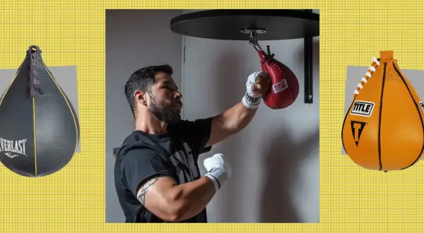 A boxer practices speed bag combos with a red Title bag. An Everlast bag is on the left, and an orange Title bag on the right.