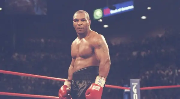Mike Tyson in the ring, ready to fight. His physique hints at the incredible strength needed to know how much Mike Tyson could bench.