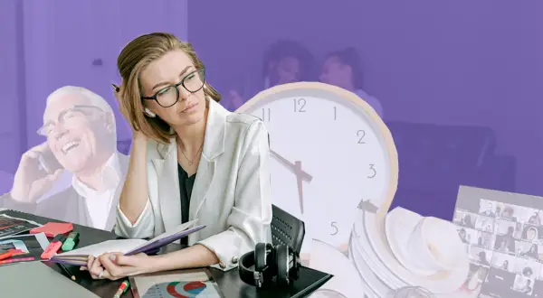 En kvinna med glasögon ser uttråkad ut vid sitt skrivbord, medan en glad man pratar i telefon i bakgrunden. Känslan av olika grupperingar på jobbet.
