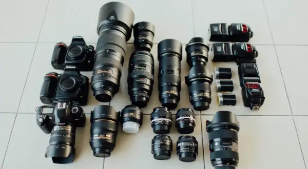 Nikon cameras and lenses laid out, a photographer's dream. Choosing the right camera depends on your needs, from portraits to landscapes.