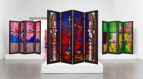 A triptych of stained glass screens, showcasing vibrant floral and mythical scenes, reminiscent of the work of famous stained glass artists.