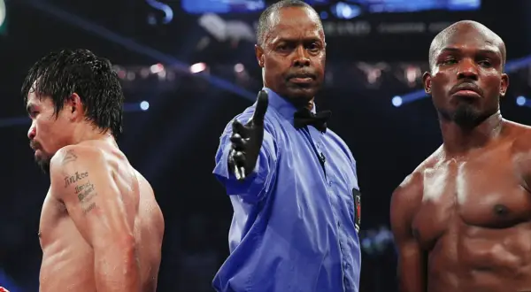 Referee signals between boxers, hinting at a close fight that could end in a majority decision vs split decision.