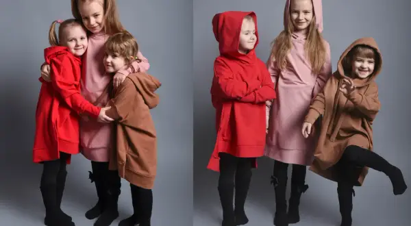 Trzy dziewczynki w modnych bluzach: dwie w czerwonych, jedna w różowej i jedna w brązowej.
