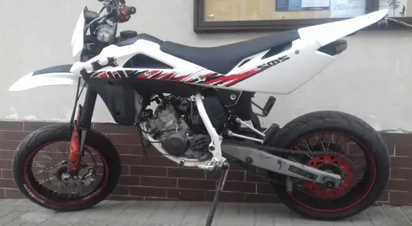 Husqvarna SM 125 z czerwono-czarnymi grafikami. Dane techniczne tego zwinnego supermoto są imponujące.