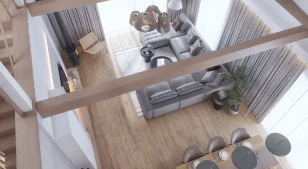 Nowoczesny salon z szarą sofą, drewnianymi belkami i jadalnią, widok z góry.
