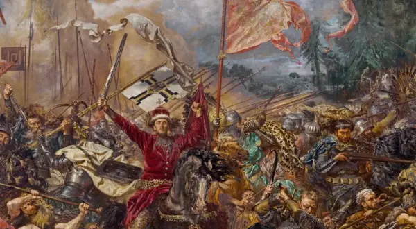 Jan Matejko ukazuje dynamiczną bitwę pod Grunwaldem. W centrum rycerz w czerwieni unosi miecz i chorągiew.