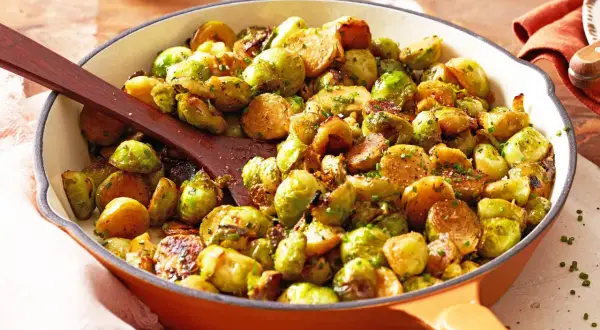 Leckere Rosenkohl Rezepte Pfanne mit gebratenem Rosenkohl und Kräutern, serviert in einer gusseisernen Pfanne.