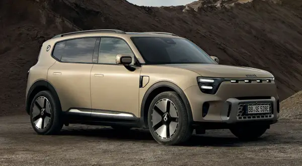 En smart 5-dörrars SUV i sandfärgad metallic står på en grusväg. Bilen har en modern design med LED-lampor och unika fälgar.