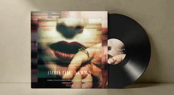 Vinyl record with album cover featuring a close-up of lips and a hand with rings.