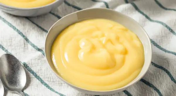 Crème anglaise on a striped cloth, a comforting dessert like crème anglaise recette grand-mère.