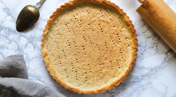 En perfekt förgräddad pajskal, redo för fyllning. Ett enkelt pajdeg recept som ger ett gyllene resultat.