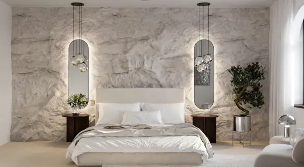 Moderne Schlafzimmer Style Ideen: Steinwand, Spiegel mit Beleuchtung, bequemes Bett und ein Olivenbaum im Topf schaffen eine luxuriöse Atmosphäre.