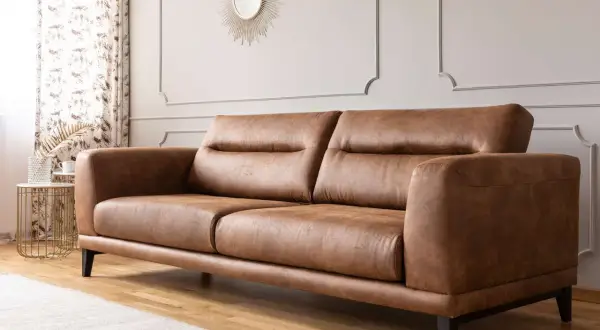 A stylish brown leather sofa, perfect for any living room. Learn how to clean leather furniture to keep it looking its best.
