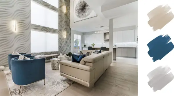 A modern living room with a textured wall, blue velvet chairs, and a cream sofa. The interior design color schemes feature beige, navy, and grey swatches.