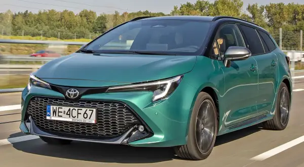 Zielony Toyota Corolla kombi w ruchu drogowym. Sprawdź aktualną toyota corolla cena i wyposażenie.