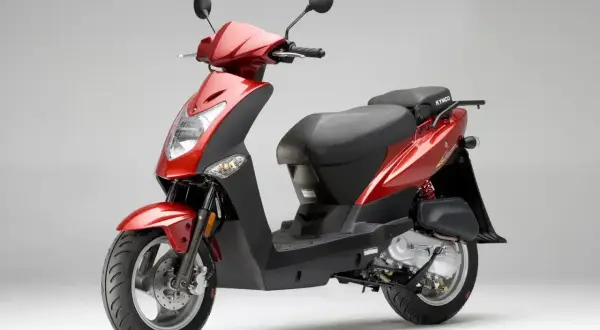Czerwony skuter Kymco, jeden z popularnych marek skuterów, gotowy do jazdy po mieście.