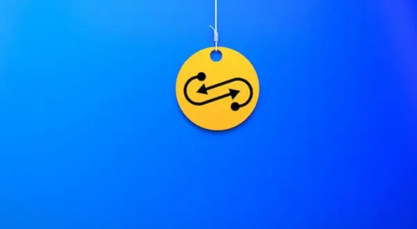 Żółty krążek z symbolem nieskończoności i strzałkami, wiszący na nitce. Czy to symbolizuje swap?