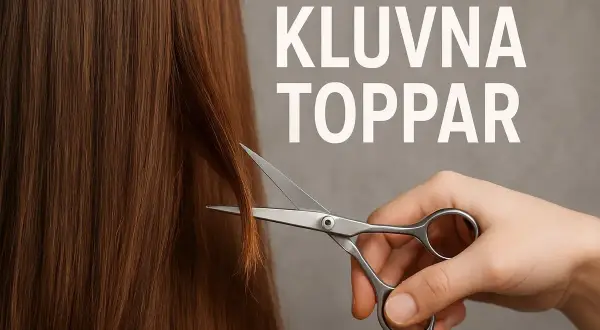 En hand håller en sax redo att klippa bort kluvna toppar från långt, brunt hår.