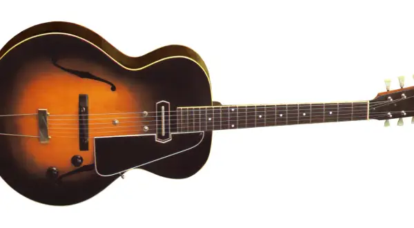 Klasyczna gitara elektryczna z wycięciami w kształcie litery "f", z przetwornikiem i kluczami. Może to być pierwsza gitara elektryczna, która rozpoczęła rewolucję w muzyce.