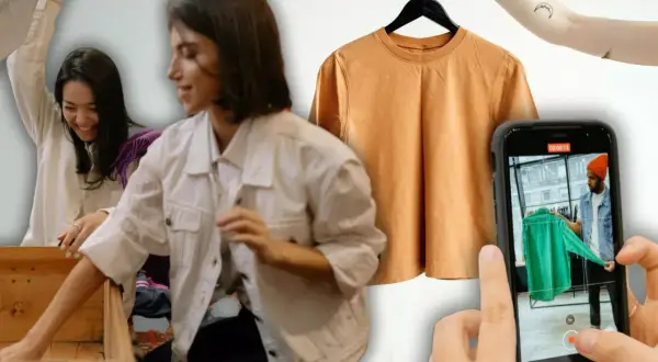 Chicas organizando ropa para vender por internet. Una camiseta naranja cuelga de una percha y un móvil graba a un hombre mostrando una prenda verde.