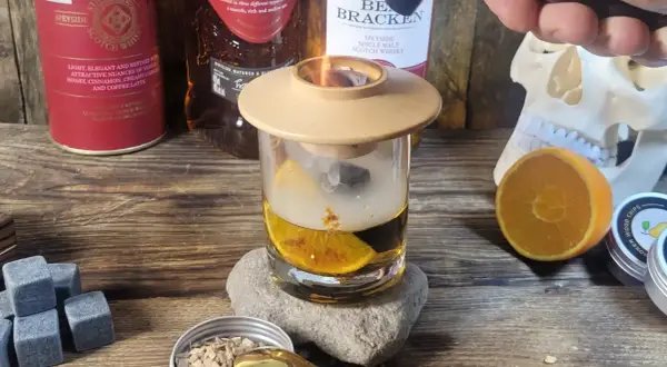 Dymiący drink z whisky, pomarańczą i kamieniami do napojów. Idealny sposób, jak zrobić drinka z whisky, by nadać mu głębi smaku.
