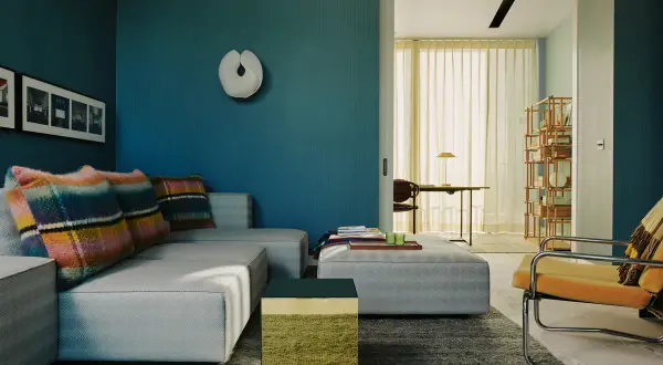 Soggiorno moderno con divano grigio, cuscini colorati e pareti blu intenso. Un tavolino cubico verde e oro aggiunge un tocco di vivacità.