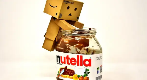 Mały robot Danbo siedzi na słoiku Nutelli, zastanawiając się nad jej kcal.