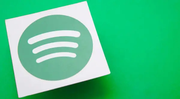 A white square with the green Spotify logo sits on a bright green surface, hinting at the platform's popularity and its impressive spotify stream count.