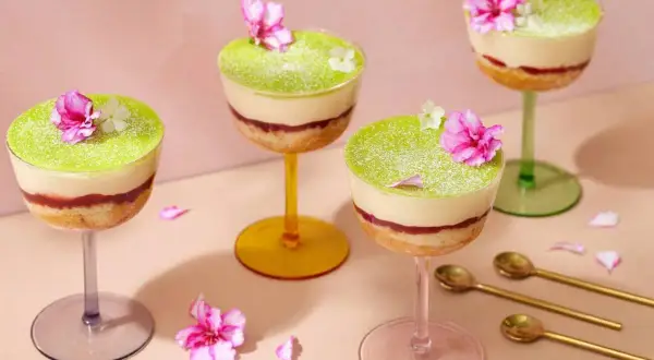 Fyra vackra prinsesstårtor i glas, dekorerade med blommor och pudrade med florsocker. En festlig dessert!