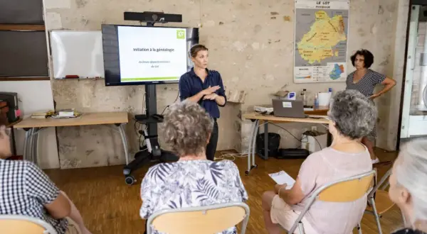 Une conférencière présente une initiation à la généalogie aux archives départementales du Lot.