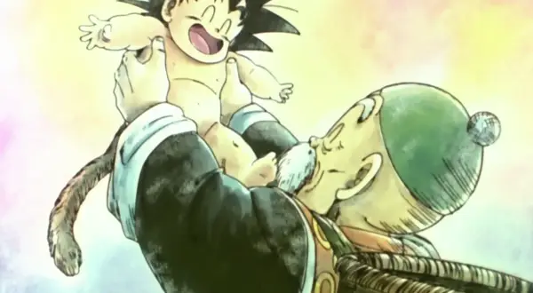 Opa Gohan hält den kleinen Son Gohan hoch. Der Junge lacht und sein Affenschwanz baumelt.