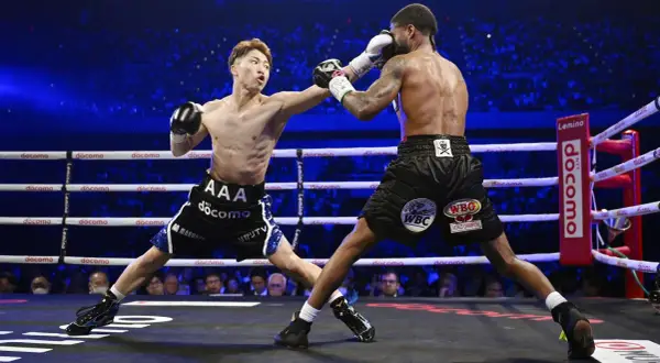 Two boxers clash in a packed arena. The frequency of how often boxers fight varies greatly depending on their level and schedule.